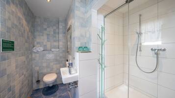 Shower, hair dryer, soap, toilet paper