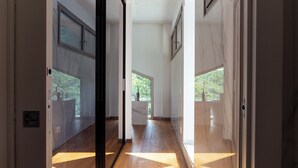 A modern hallway with wooden flooring and large windows allowing natural light. - LA FORESTALE Luxury Ecolodge (Acqualagna)