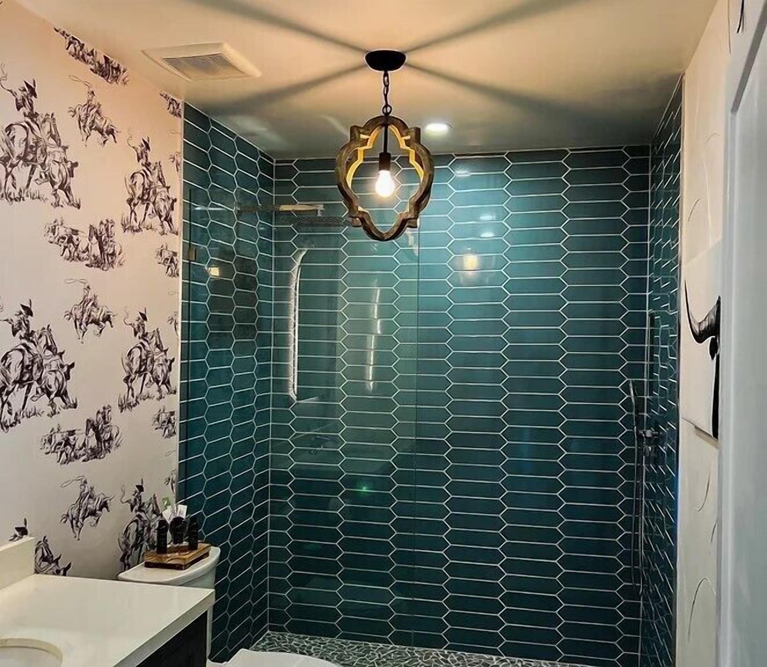 A bathroom with a hexagonal tile pattern, a shower area, and a toilet.
