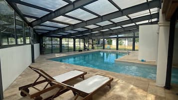 Indoor pool, pool umbrellas, pool loungers