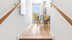 A staircase leading to a dining area with a view. - GuestReady - Riverside Retreat with Terrace Views (Vila Nova de Gaia)