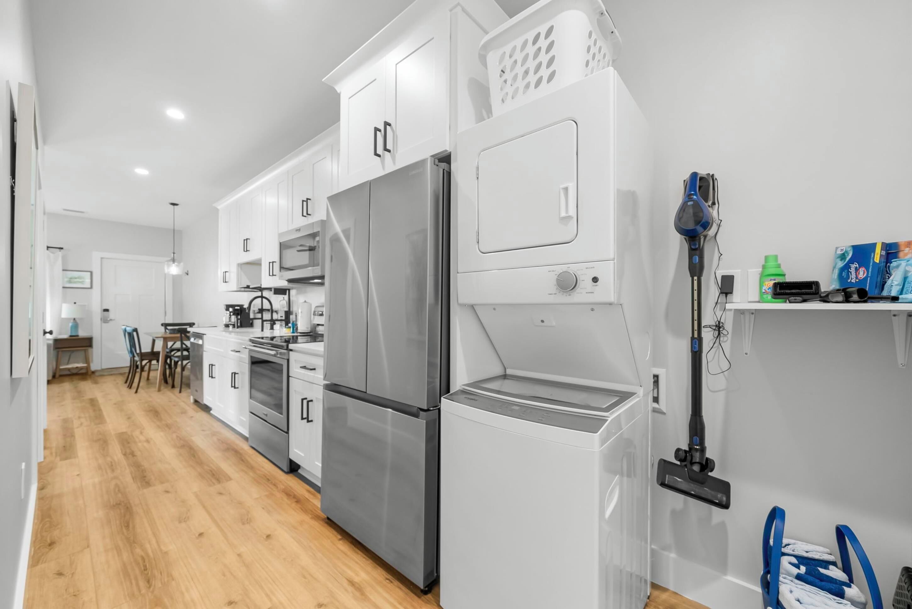 A modern kitchen with stainless steel appliances, a built-in oven, and a dishwasher.