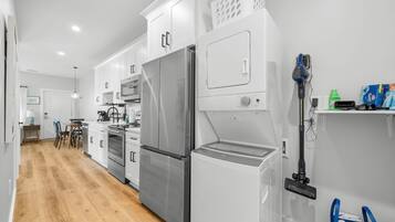 A modern kitchen with stainless steel appliances, a built-in oven, and a dishwasher.