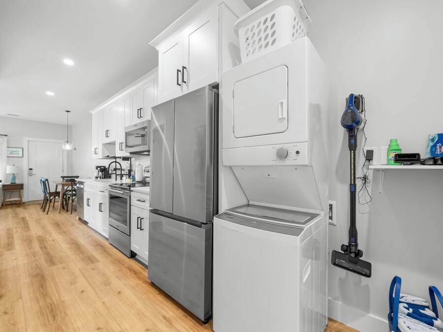 A modern kitchen with stainless steel appliances, a built-in oven, and a dishwasher.