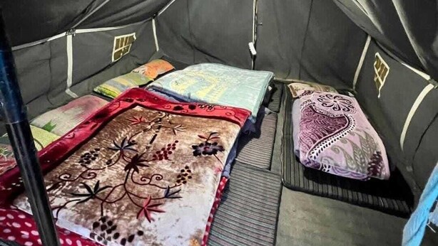 A tent with a bed, pillows, and a blanket. - YATRA DHAM CAMP KEDARNATH  (Kedarnath)