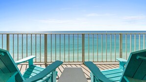 A balcony with turquoise chairs overlooking a clear blue sea. - Fall Deals + Snowbird Rates | Gulf Front Beach Escape (Panama City Beach)