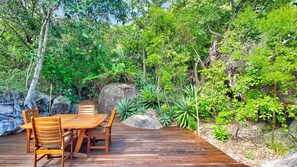 Enjoy dining al fresco amidst lush greenery and a serene waterfall backdrop.