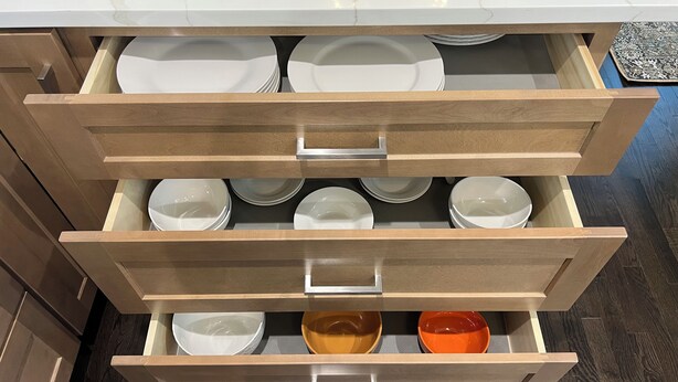 A kitchen drawer with multiple compartments, each containing white plates and bowls. - Elegant Escape by Downtown Burr Ridge with an easy access to Chicago Landmarks (La Grange)