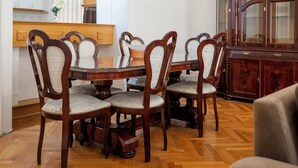 Un coin repas avec une table et des chaises en bois, un buffet et un miroir.