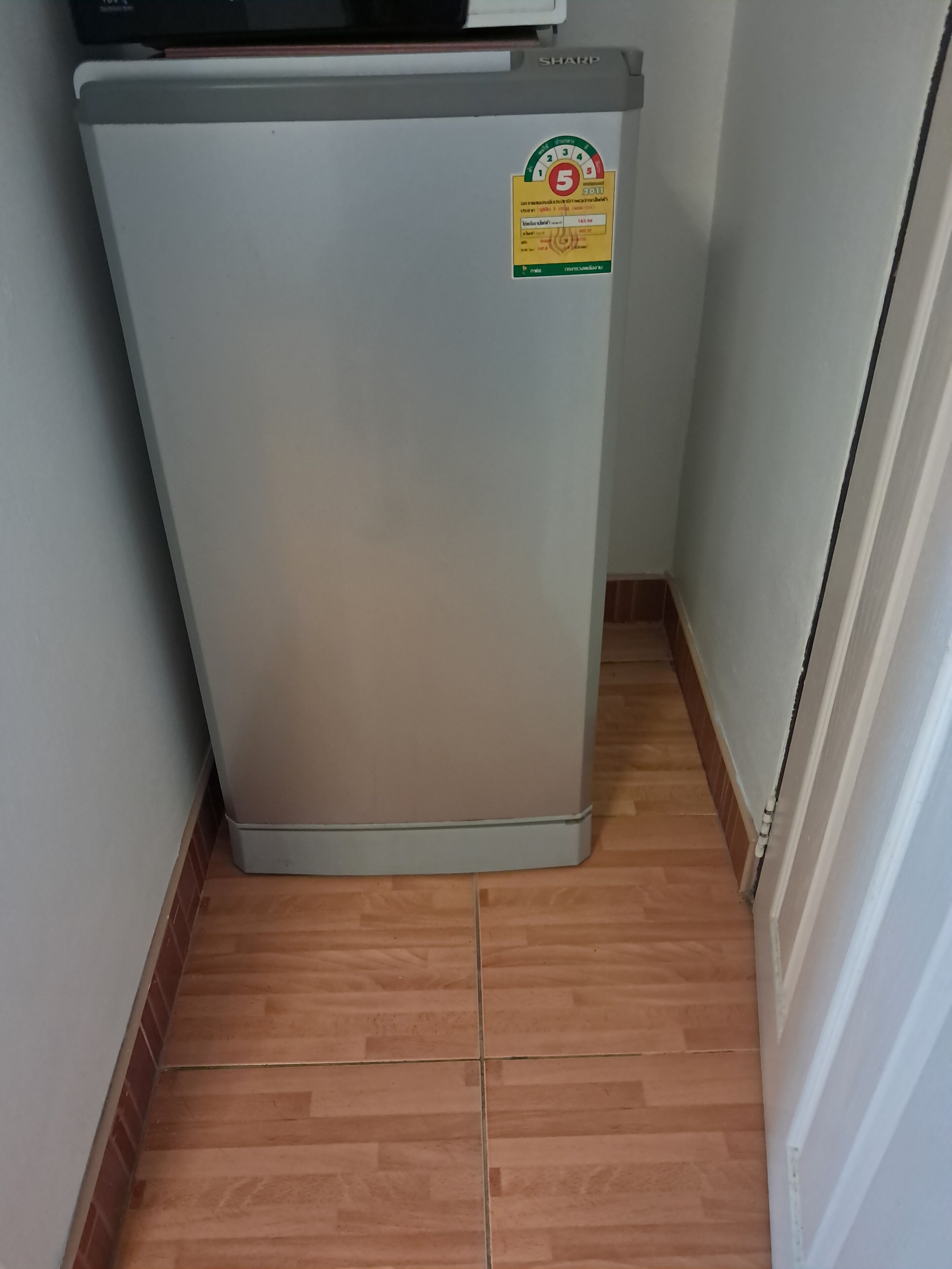 A compact refrigerator with a sticker indicating a 5-star rating.