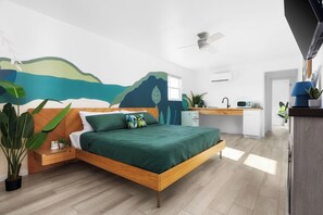 A modern bedroom with a wooden bed, a desk, and a kitchen area. - Motel Miya (Rockport)