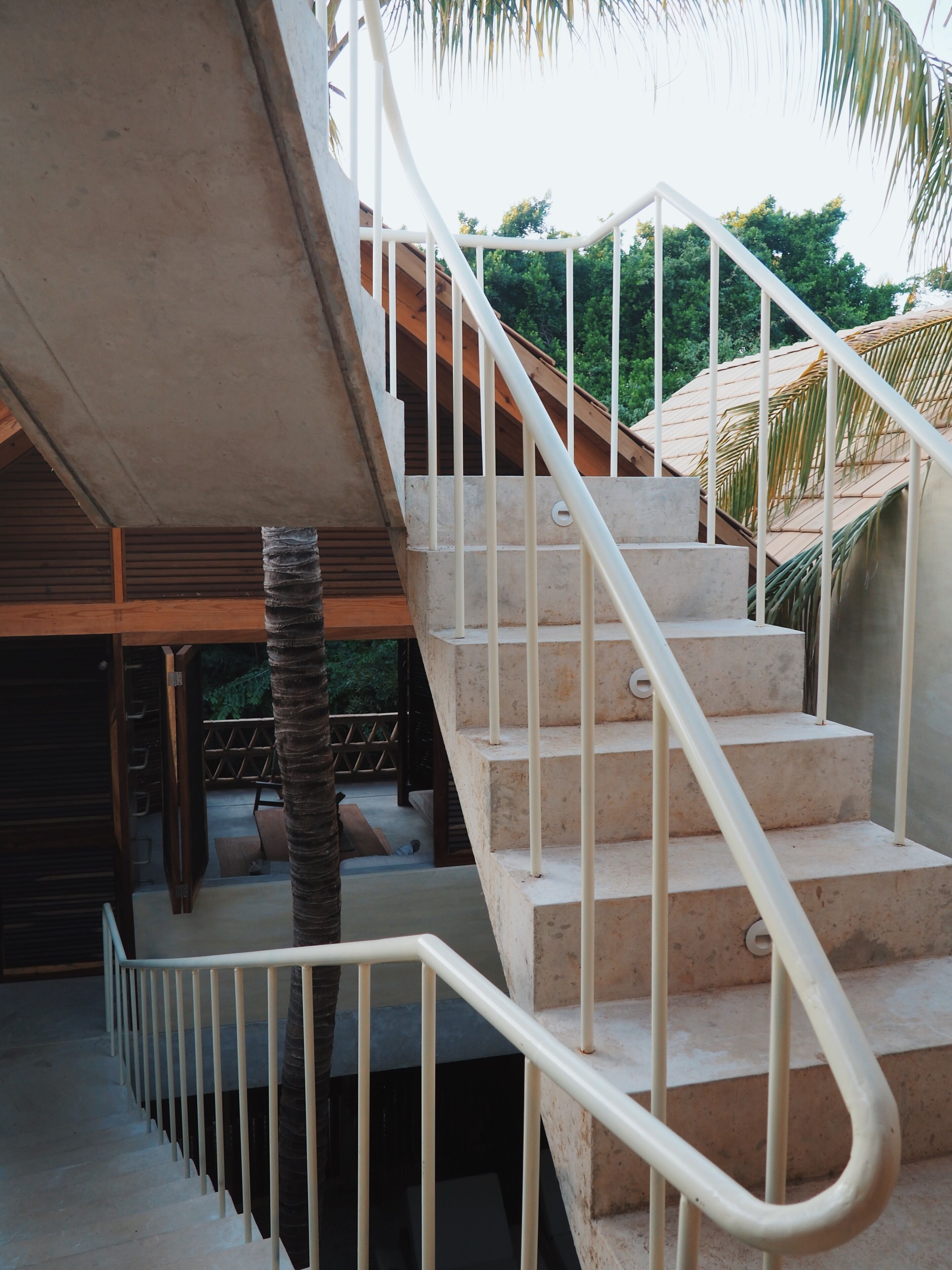 A staircase with white railings leading to an upper level.