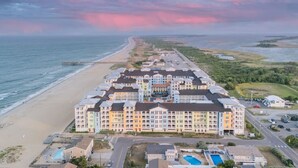 A coastal hotel with multiple buildings, a beach, and a swimming pool. - New! 3Bd 2Bth Oceanfront / Pool / Boat /224b (Virginia Beach)