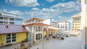 A resort with multiple buildings, outdoor seating areas, and a pool. - New! 3Bd 2Bth Oceanfront / Pool / Boat /224b (Virginia Beach)