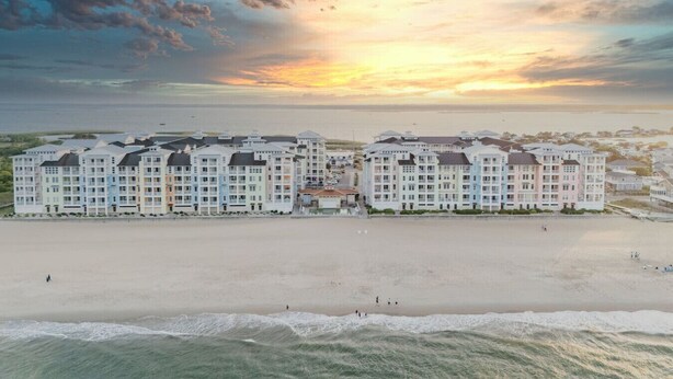 A beachfront hotel with multiple buildings, a sandy beach, and the ocean. - New! 3Bd 2Bth Oceanfront / Pool / Boat /224b (Virginia Beach)