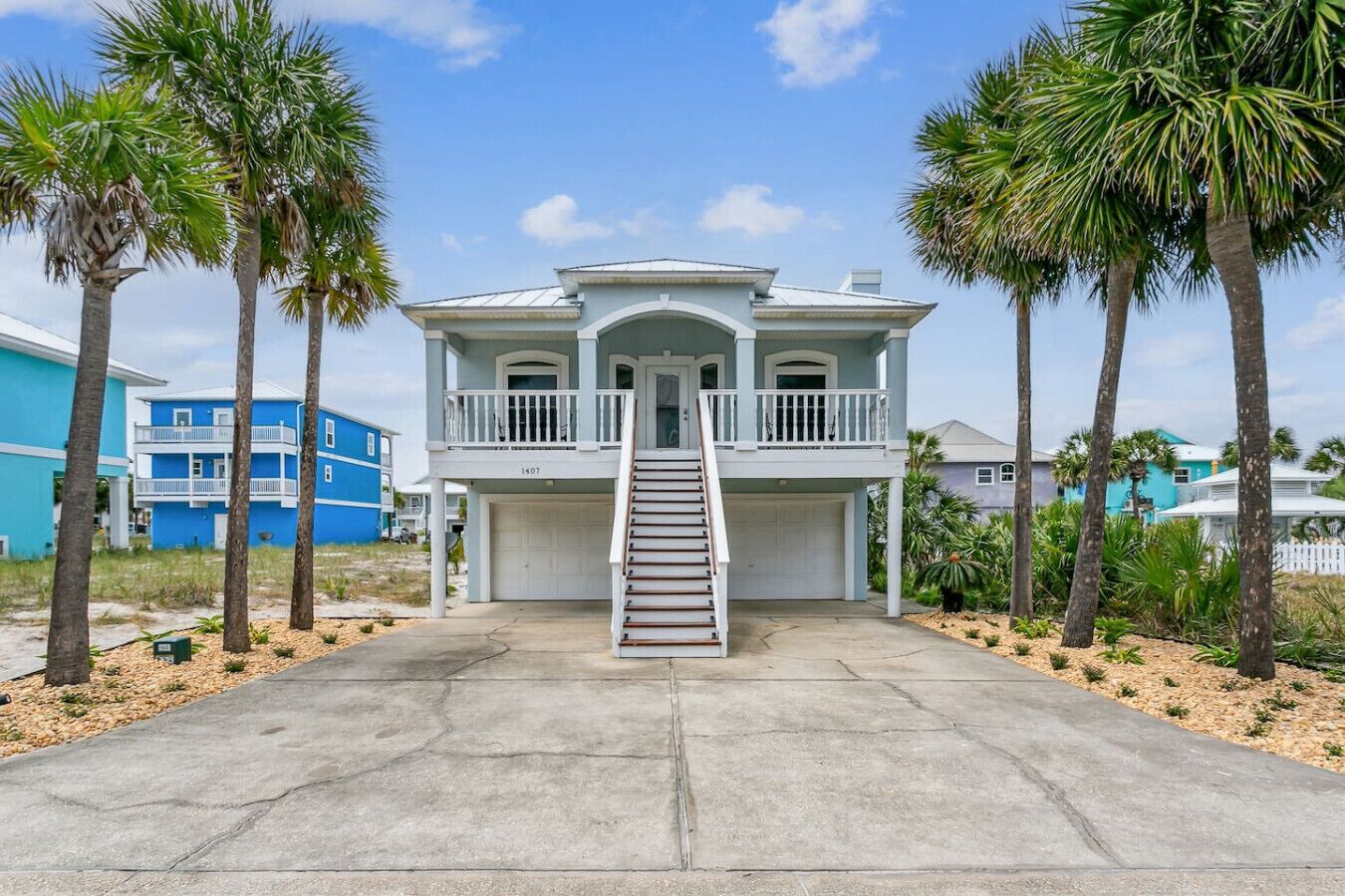 A two-story house with a front porch, a staircase, and a garage.