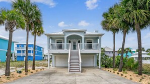 A two-story house with a front porch, a staircase, and a garage.