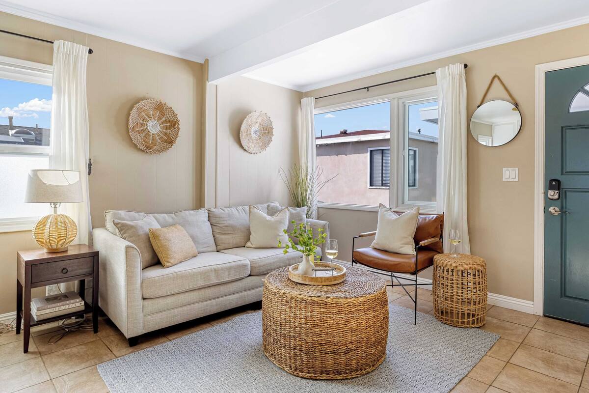 A living room with a sofa, a coffee table, a side table, and a chair.