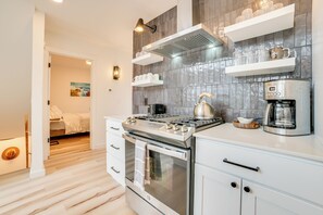 Enjoy cooking in this well-equipped kitchen with a stove, oven, kettle, and coffee maker.