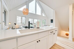 Enjoy cooking in this spacious kitchen with a large island, white cabinetry, and ample counter space.