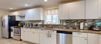 Charming coastal home with sunny rooms, private backyard, & walk to beach
