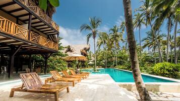 Una piscina al aire libre, tumbonas