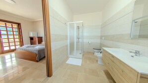 A modern bathroom with a shower, toilet, and vanity.