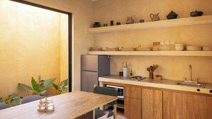 A modern kitchen with wooden cabinets, a built-in oven, and a sink. There are shelves above the counter holding various kitchen items.