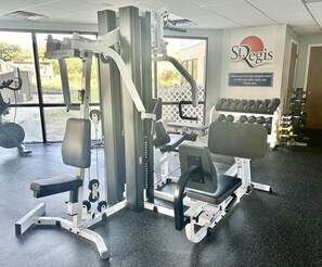 A gym with exercise equipment, a bench, and dumbbells. - Sunrise & Serenity - St. Regis Condo #3001 (N. Topsail Beach)