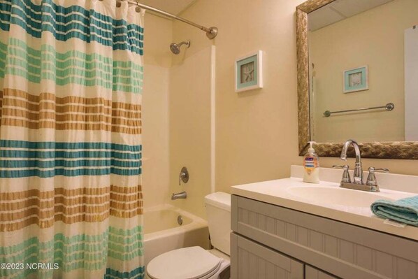 A bathroom with a bathtub, toilet, and sink. - Sunrise & Serenity - St. Regis Condo #3001 (N. Topsail Beach)