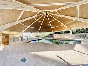 An indoor swimming pool with a wooden ceiling and tiled floor. - Sunrise & Serenity - St. Regis Condo #3001 (N. Topsail Beach)