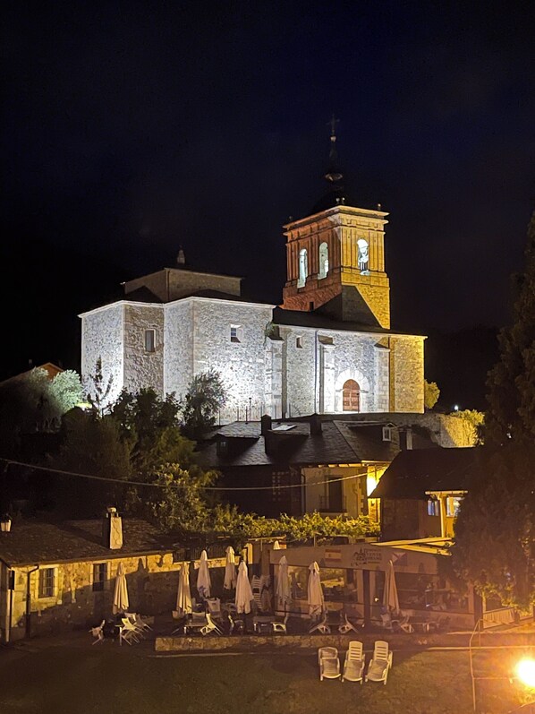 A stone building with a bell tower, illuminated at night. - THE WAY HOTEL & SUITES (Molinaseca)