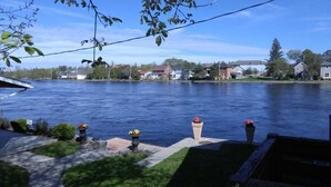 A residential area with a river, houses, and a dock. - The Water's Edge Inn (Campbellford)