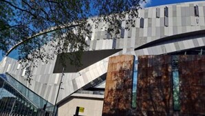 A modern building with a curved glass facade and a prominent wooden structure. - Bruce Rooms – Your Comfortable Retreat in Tottenham (London)