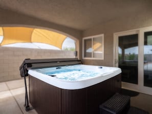 A hot tub with a wooden exterior, a window, and a yellow canopy in the background. - Hot Tub, Game Room, Strip Views, No Fees (North Las Vegas)