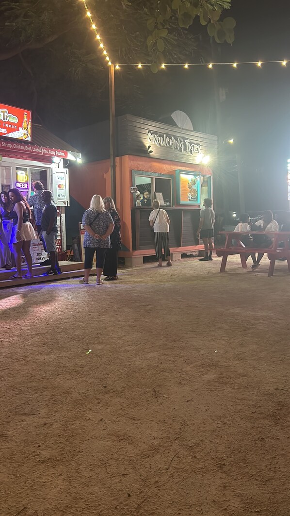 A food truck named "Gourmet Tiger" with a menu board visible.