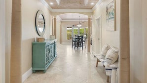 A hallway with a dining area, a green cabinet, and a bench. - NEW 3 BDR villa near Jolly Hall beach and Turtle beach in Welcoming George Town (George Town)
