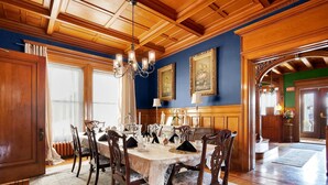 A formal dining room with a wooden ceiling, a chandelier, and a table set for six. - Victoria Mansion 1895, Near SBU - AA Milne Room! (Olean)