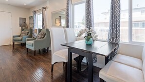 A dining area with a wooden table, two chairs, and a bench.