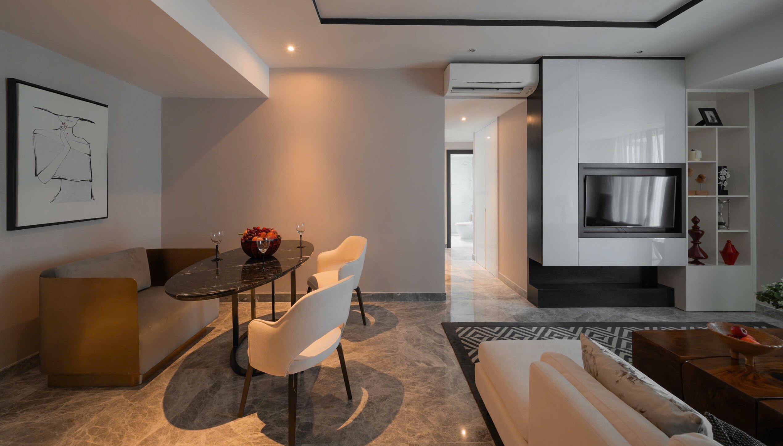 A modern living room with a dining area, a sofa, a TV, and a fireplace.