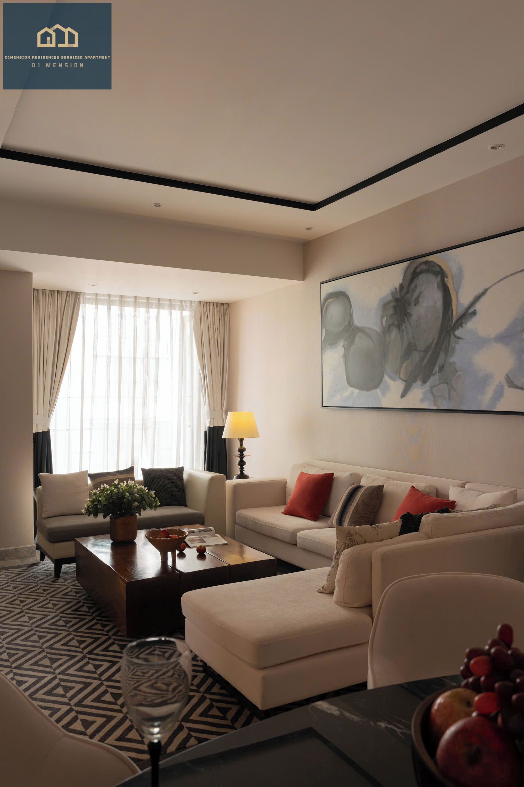 A modern living room with a sofa set, a coffee table, and a large abstract painting on the wall.