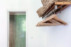 A room with a sliding door, a wall-mounted wooden hanger, and a woven basket. - villa Casasco - MyHomeinComo (Casasco d'Intelvi)