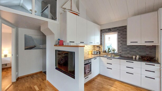 A modern kitchen with white cabinetry, a built-in oven, and a wooden floor. - 1 bedroom cozy home in Skummeslöv (Skummeslöv)