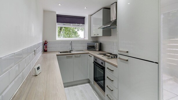 A compact kitchen with a built-in oven, a microwave, and a gas stove. - Beacon Fell Cottage 2 (Longridge, Ribble Valley)