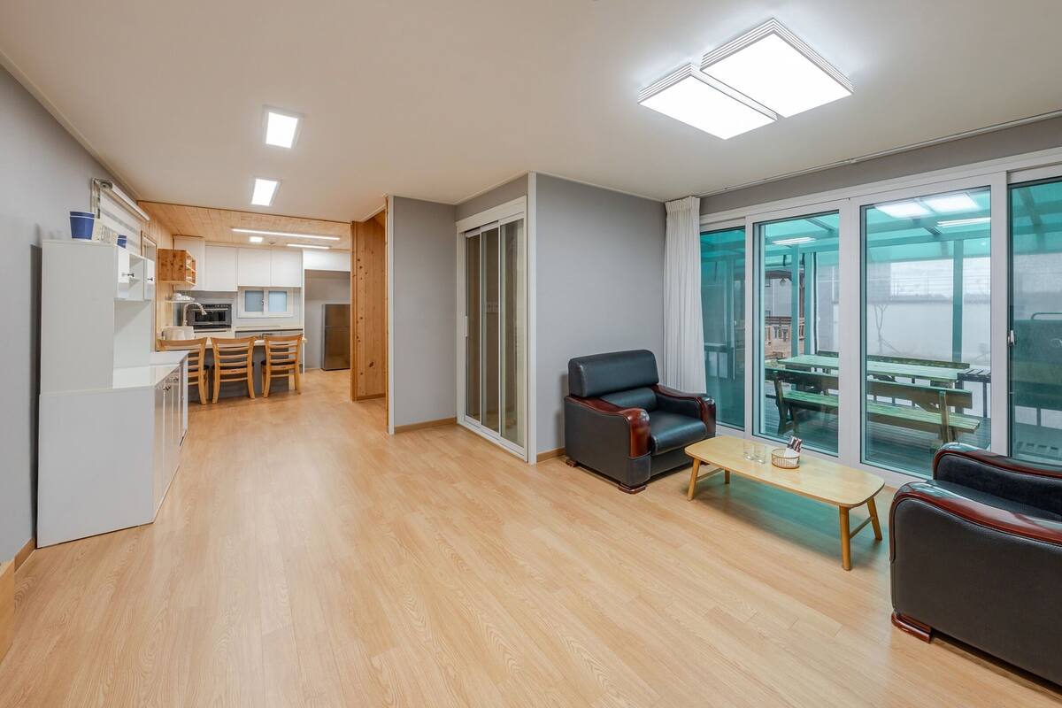 A modern apartment with a kitchen, dining area, and a balcony with a view.