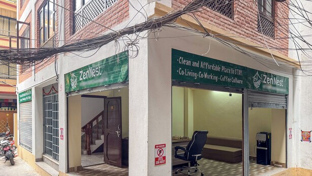 A ZenNest property with a clean entrance, a staircase leading inside, and a no parking sign. - Zen Nest Hotel (Kathmandu)