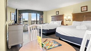 A hotel room with two beds, a desk with a chair, a dresser, and a view of the outdoors. - Oceanview Vibes! Compass Cove Studio Retreat (Myrtle Beach)
