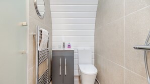 A bathroom with a toilet, sink, and shower. - Lakeside Micro Lodge (Pet) (Scarborough)