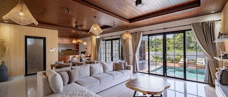Deluxe Villa, 2 Bedrooms, Patio, Pool View | Living room | 50-inch TV with cable channels