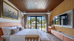 A spacious bedroom with a large bed, a TV, and a view of the outdoors. - The Lotus Villa Uluwatu (Ungasan)